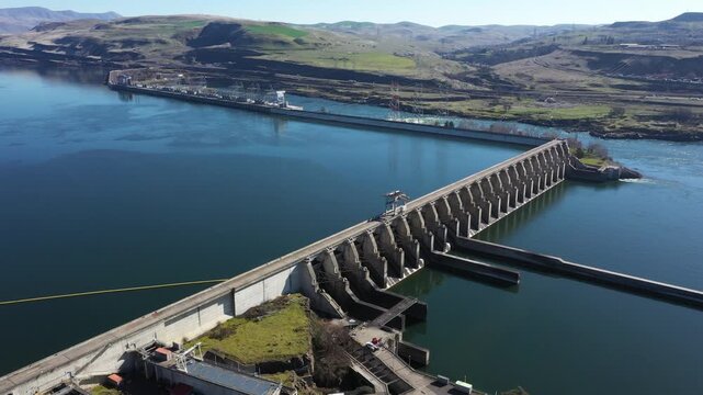 4K Aerial drone footage of The Dalles Dam hydroelectric facility on the Columbia River in The Dalles, Oregon, USA generating renewable energy and supplying electricity to the regional power grid