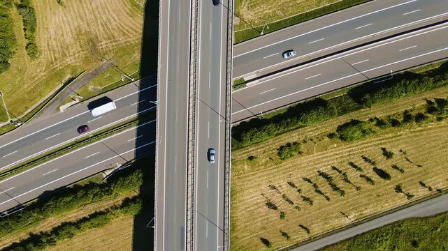 High Vantage Point Reveals Persistent Vehicle Flow With Scattered Cars During Midday Hours