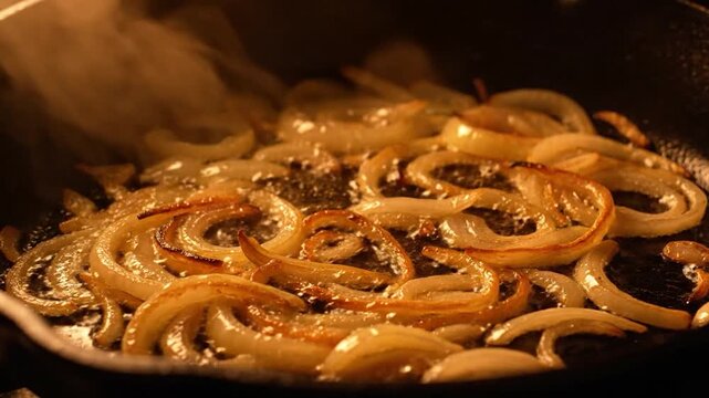 Close-up of Sizzling Caramelized Onions Frying in a Hot Pan, Creating a Delicious Aroma and Golden-Brown Texture.