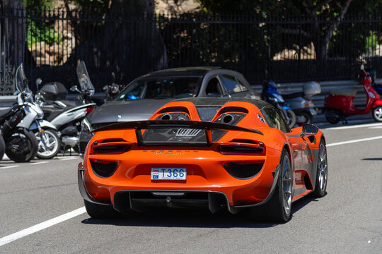 Monte Carlo, Monaco - June 1st 2019 : View on an orange Porsche 918 Spyder Weissach Package finished in Lava orange driving on the road in the Fairmont Hairpin.