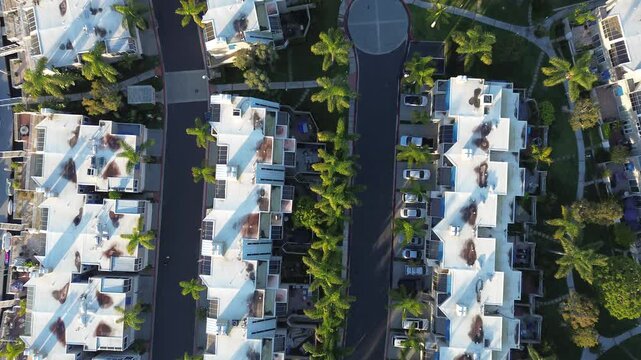 Symmetric residential spine centered along Seabridge Village North internal drive near Countess Dr. Repeating roof patterns, solar panels, pavement form balanced visual grid, Huntington Beach, CA