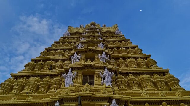 Drone view of the golden gopuram of Sri Chamundeshwari Temple adorned with goddess sculptures