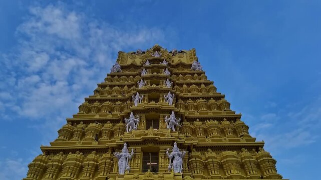 Drone view of the golden gopuram of Sri Chamundeshwari Temple adorned with goddess sculptures
