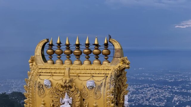 Cinematic drone view of golden kalasa atop Sri Chamundeshwari Temple gopuram, Chamundi Hills,Mysore