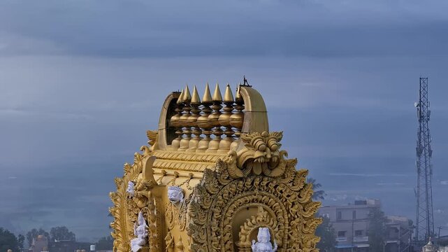 Cinematic drone view of golden kalasa atop Sri Chamundeshwari Temple gopuram, Chamundi Hills,Mysore