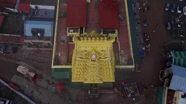 Drone view of the golden gopuram of Sri Chamundeshwari Temple adorned with goddess sculptures