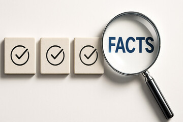 Fact-checking and truth validation concept. Abstract background with magnifying glass highlighting word FACTS beside tiles with checkmarks symbolizing verification, accuracy, and information scrutiny.