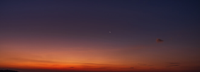 Minimal twilight sky with crescent moon and soft warm horizon colors.