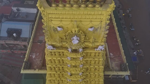 Drone view of the golden gopuram of Sri Chamundeshwari Temple adorned with goddess sculptures