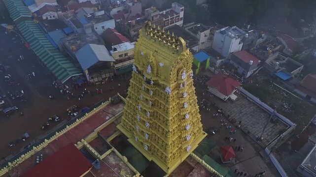 Drone view of the golden gopuram of Sri Chamundeshwari Temple adorned with goddess sculptures