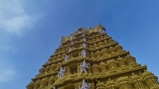 Drone view of the golden gopuram of Sri Chamundeshwari Temple adorned with goddess sculptures