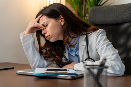 Burnout, stress or doctor woman on laptop with headache from depression, mental health or anxiety medical review. Tired, pain or sad nurse frustrated, angry or depressed for medicine report in office