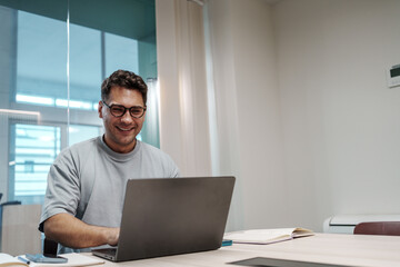 Fototapeta premium Man Coding Happily. White Male Software Engineer Concluding Productive Day With Contented Look