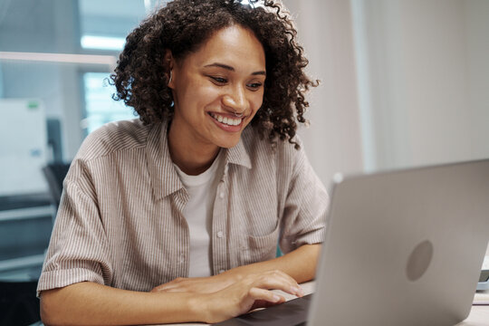 Friendly Woman Smiling While Assisting Customers Through Digital Communication From Remote Location
