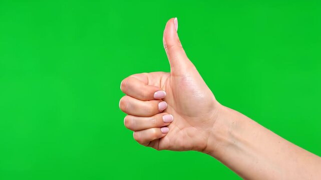 A hand giving a thumbs up gesture in a positive affirmation on a green screen preview