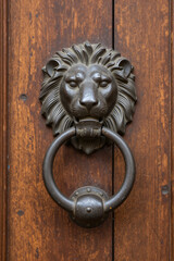 Vintage Lion Head Door Knocker on Rustic Wooden Door Closeup Detailed Antique Metal Hardware for Home Entrance or Luxury Property