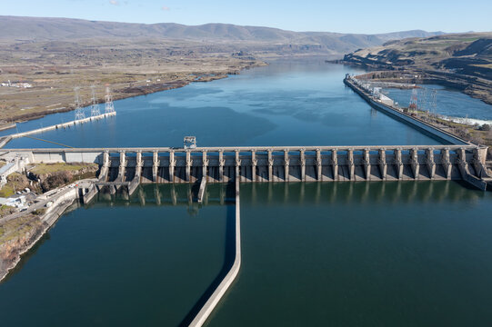 Aerial drone footage of The Dalles Dam hydroelectric facility on the Columbia River in The Dalles, Oregon, USA generating renewable energy and supplying electricity to the regional power grid
