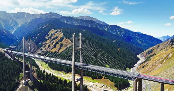 Aerial view of Guozigou cable-stayed bridge spanning a mountain valley in Xinjiang, China.
