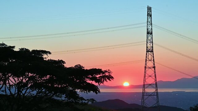 阿蘇の夕暮れ：オレンジ色に染まる熊本市街地と有明海の絶景
「沈みゆく夕日が熊本市街と有明海を黄金色に染め、遠くには雲仙普賢岳の堂々たる姿を捉えています。」
グリーンロード南阿蘇展望所　通称『ケニーロード』
Sunset in Aso: A spectacular view of Kumamoto City and the Ariake Sea bathed in orange.