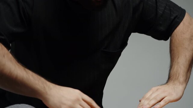 Close-up sequence of a practitioner warming hands and performing preparatory massage techniques over a person's leg, emphasizing soothing touch, balanced pressure, and bodywork