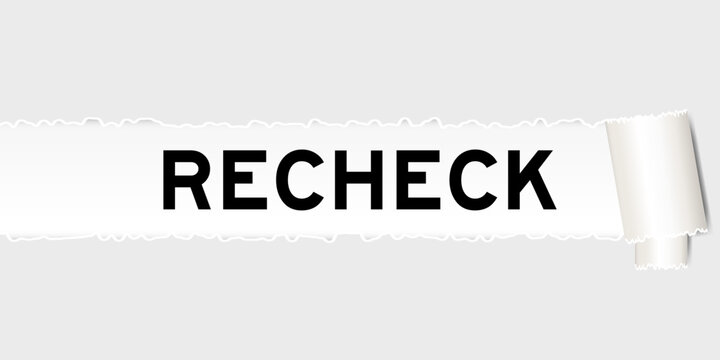 Ripped gray paper background that have word recheck under torn part