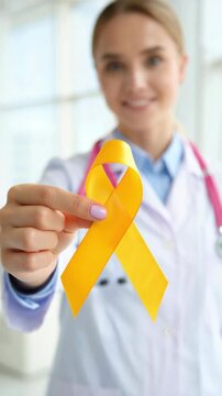 Yellow ribbon in doctor hand, endometriosis awareness month support, chronic pelvic pain education, reproductive health campaign outreach, gynecology clinic communication, fertility center marketing