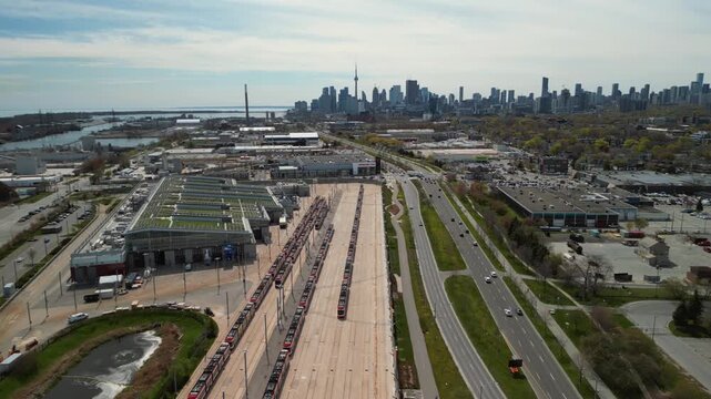 Aerial View of Toronto's Red Streetcar Fleet Lined Up at Transit Yard with Iconic City Skyline