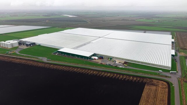 Aerial drone view of a commercial glasshouse and green energy production facility in Cambridgeshire, UK