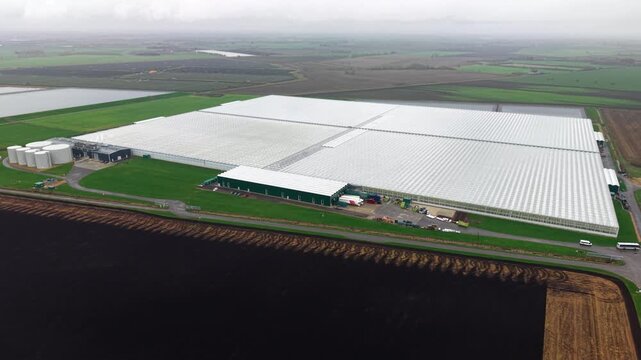 Aerial drone view of a commercial glasshouse and green energy production facility in Cambridgeshire, UK