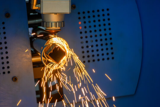 High-precision fiber laser cutting of a stainless steel pipe using advanced CNC technology and assist gas.