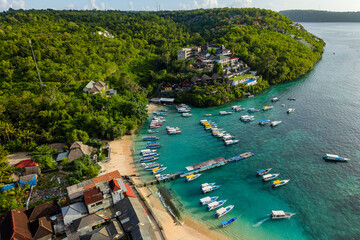 Aerial view of boats anchored in clear turquoise water at Toyapakeh, Nusa Penida, Bali © whitcomberd