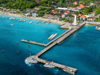 Fototapeta premium Passengers walking along the bustling pier at Nusa Penida port over clear blue water