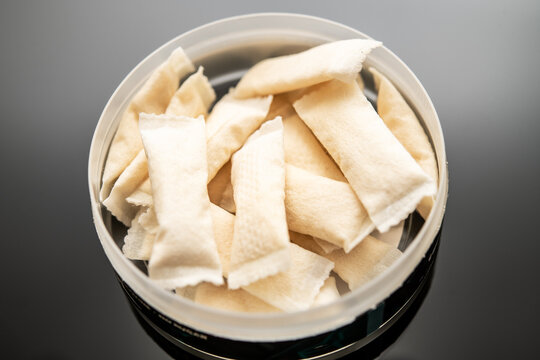 Closeup of Nicotine Pouches in Open Container on Black Surface