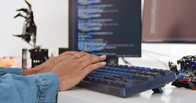 Close up of female engineer developer type on computer keyboard at home office with robotic arms. Science and technology, Robot automated innovation, Electrical engineering manufacturing concept