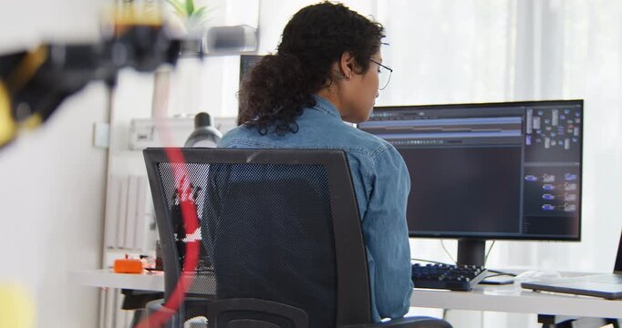 South east asian female engineer developer use laptop computer work at home office with robotic arms. Science and technology, Robot automated innovation, Electrical engineering manufacturing concept.