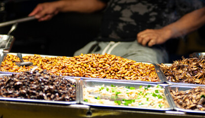Fried silkworms and crickets at Thai street food market at Bangkok Thailand Night Market digitally generated image stock photo copy space © AnnyPenny