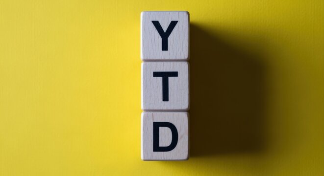 Year to Date Wooden Blocks on Yellow: Financial Performance Indicator Concept