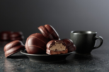 Chocolate-covered coffee souffl&eacute; cookies and cup of black coffee.