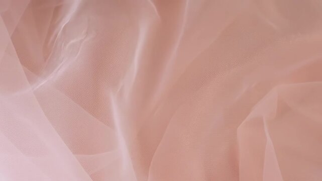 Nylon Fabric with Soft Folds Moving Across a Beige Background, Texture and Softness of the Material