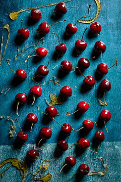 Whole Fresh Cherries with Spun Sugar on Blue Background Top View