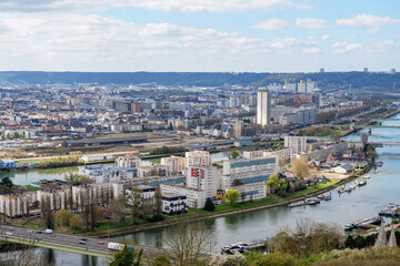 Obraz premium Rouen urban panorama with cathedral towers, bridges and river bends viewed from Cote Sainte Catherine hill. Iconic Normandy travel destination showing historic architecture and city landscape