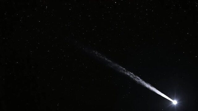 Bright Meteoroid Streaking Across Dark Night Sky with Fiery Tail.