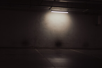 Empty parking lot with overhead dim light © Vlad Ispas