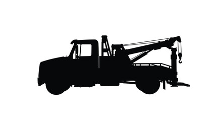 A black silhouette of a tow truck with a raised boom silhouette © MSTALYA