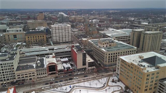 Aerial drone view of downtown Akron Ohio with snowy park and church towers