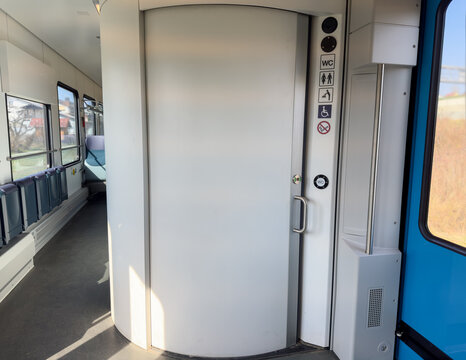 Modern accessible train toilet, WC with sliding door and disability signs. Public transport interior focusing on inclusive design and travel comfort.