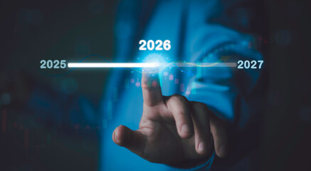 Businessman pointing at 2026 year text, Strategic future planning, business forecasting, long-term...