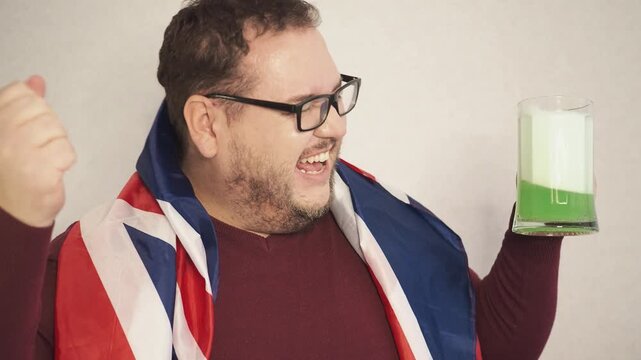 Portrait of overjoyed bearded man standing with excited expression, raising fists, screaming, shouting yeah, celebrating his victory, success.