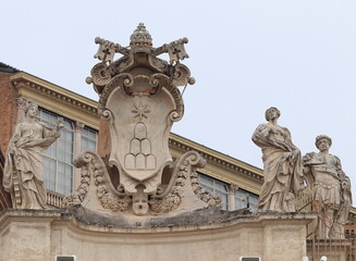 St. Peter's Basilica Exterior Detail with Sculpted Papal Coat of Arms and Statues in Rome, Italy
