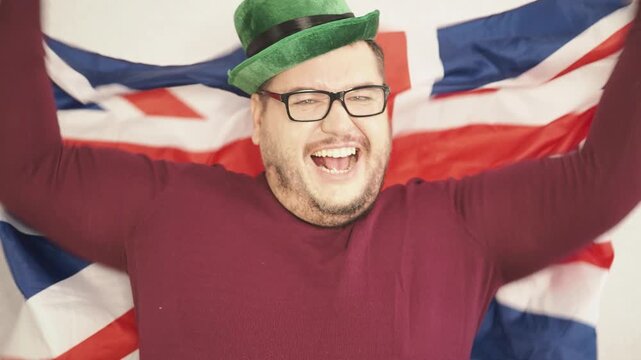Portrait of overjoyed bearded man standing with excited expression, raising fists, screaming, shouting yeah, celebrating his victory, success.